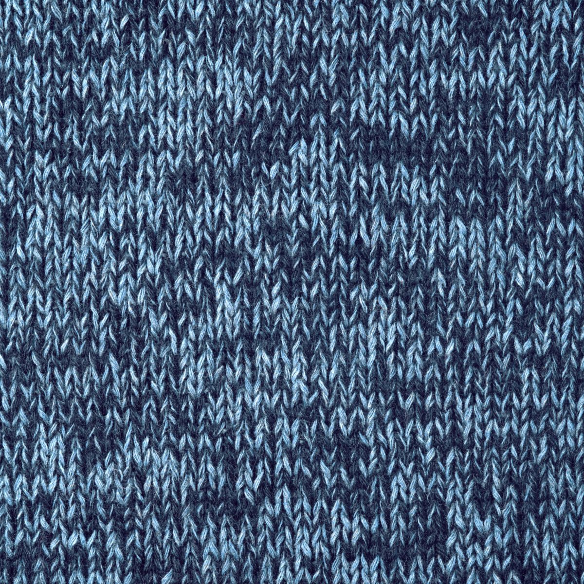 Knitted background. Texture of knitted woolen fabric close up.